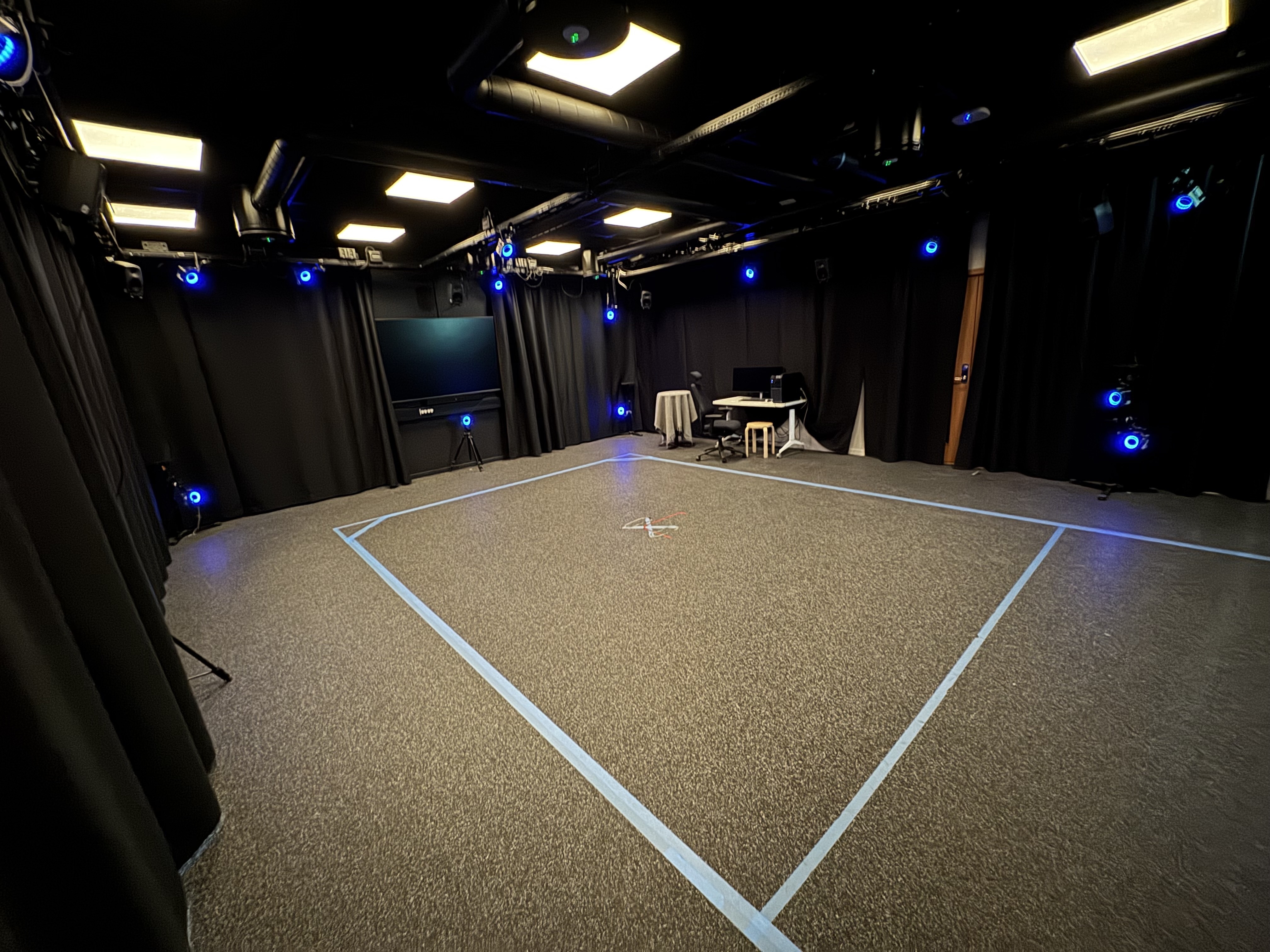 PMIL studio wide shot — full open floor with motion capture volume marked